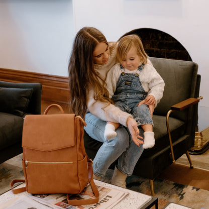 Busy parent with Florence Tan diaper Bag during day out with baby