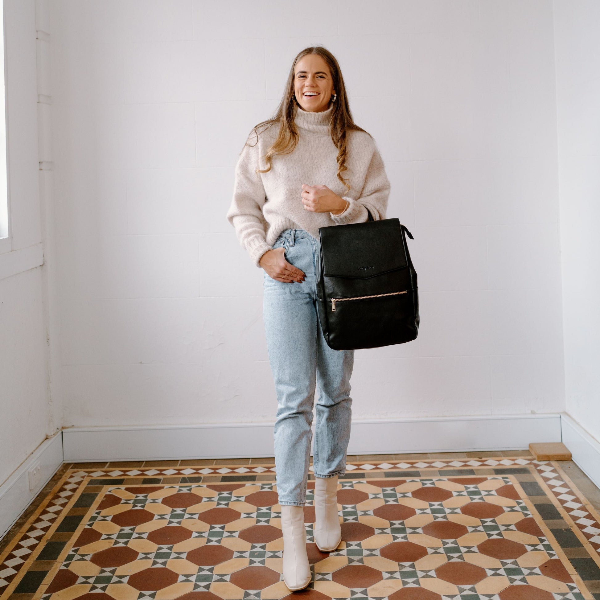 Stylish parent wearing Florence Black Nappy Bag on her arm