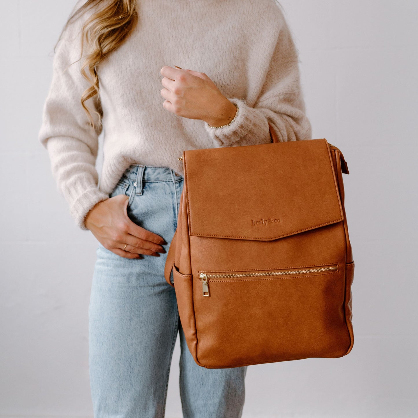 Detail of tan vegan leather texture and premium hardware on Florence Diaper Bag
