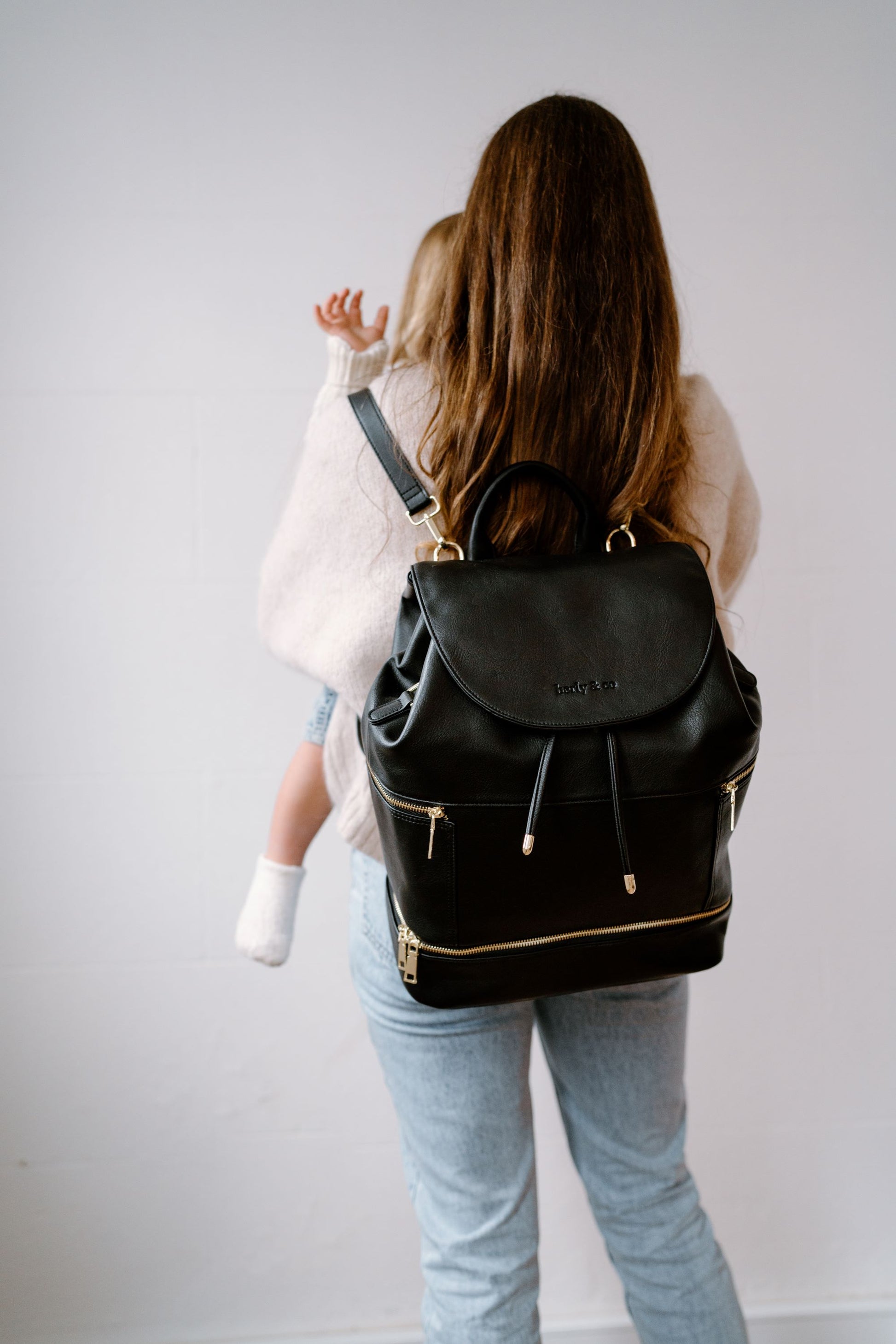 Modern parent with Siena Black Nappy Bag during outing with baby