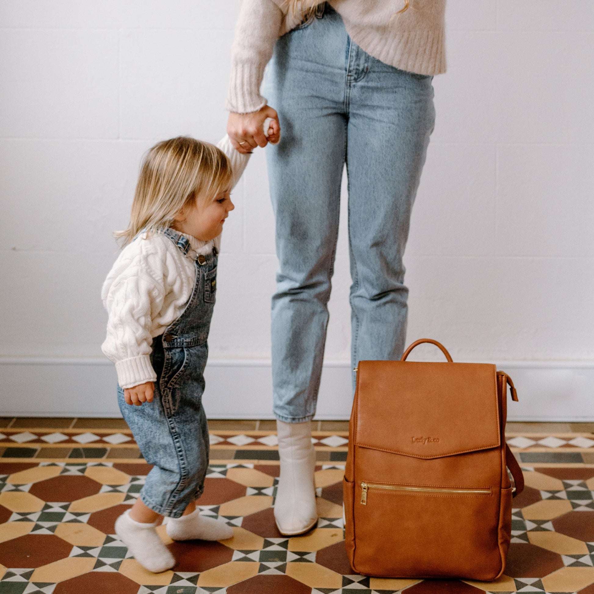 Busy parent with Florence Tan Nappy Bag during day out with baby