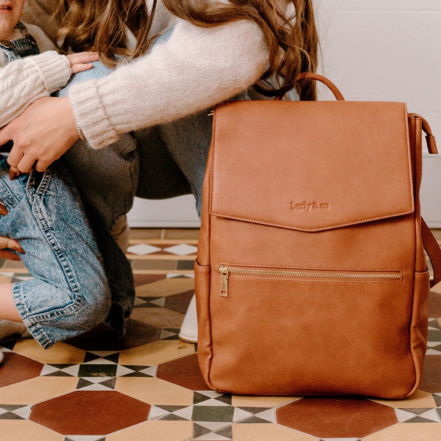 Busy parent with Florence Tan Nappy Bag during day out with baby