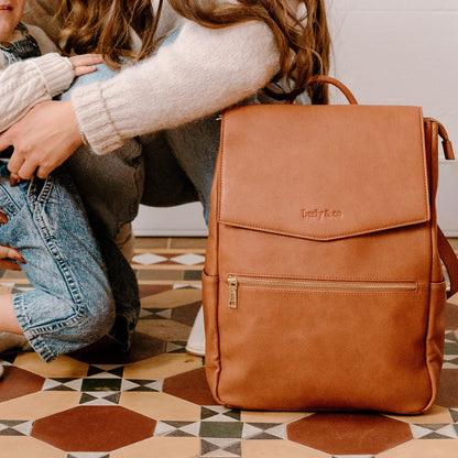 Busy parent with Florence Tan Nappy Bag during day out with baby