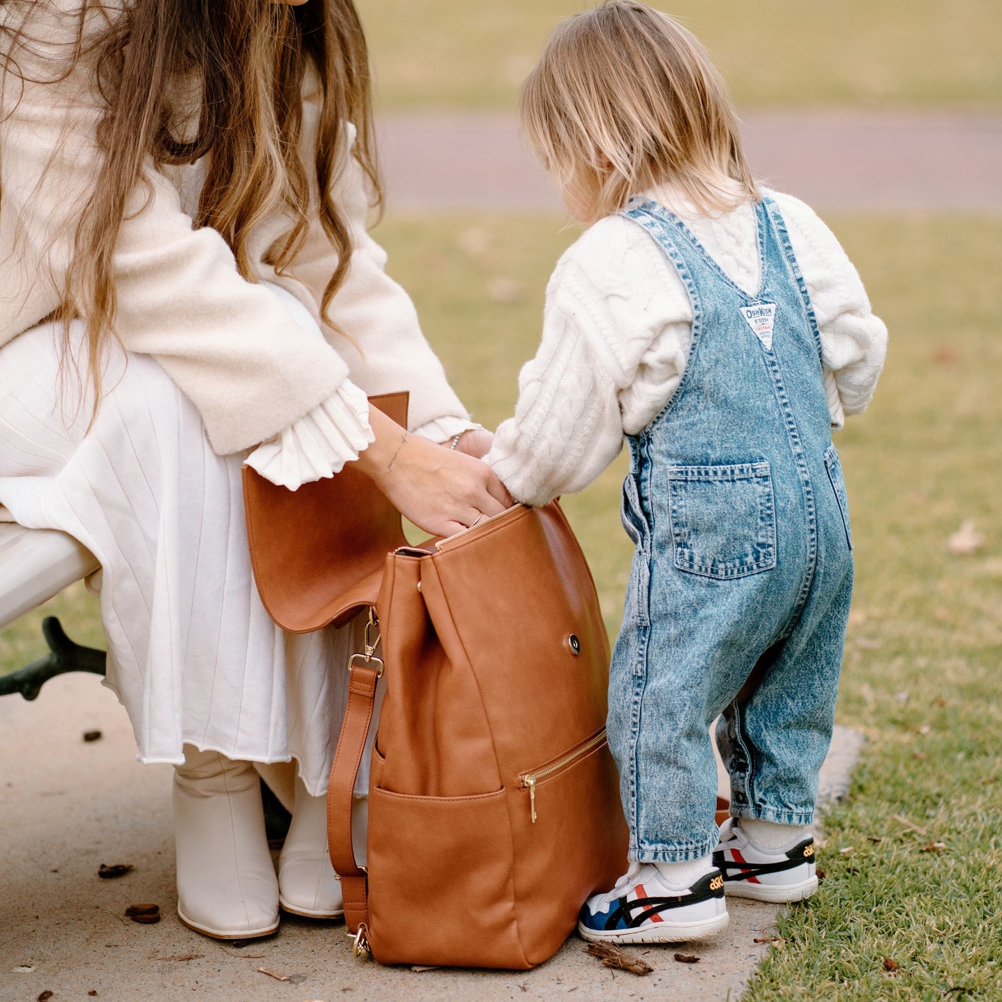 Busy parent with Florence Tan Nappy Bag during day out with baby