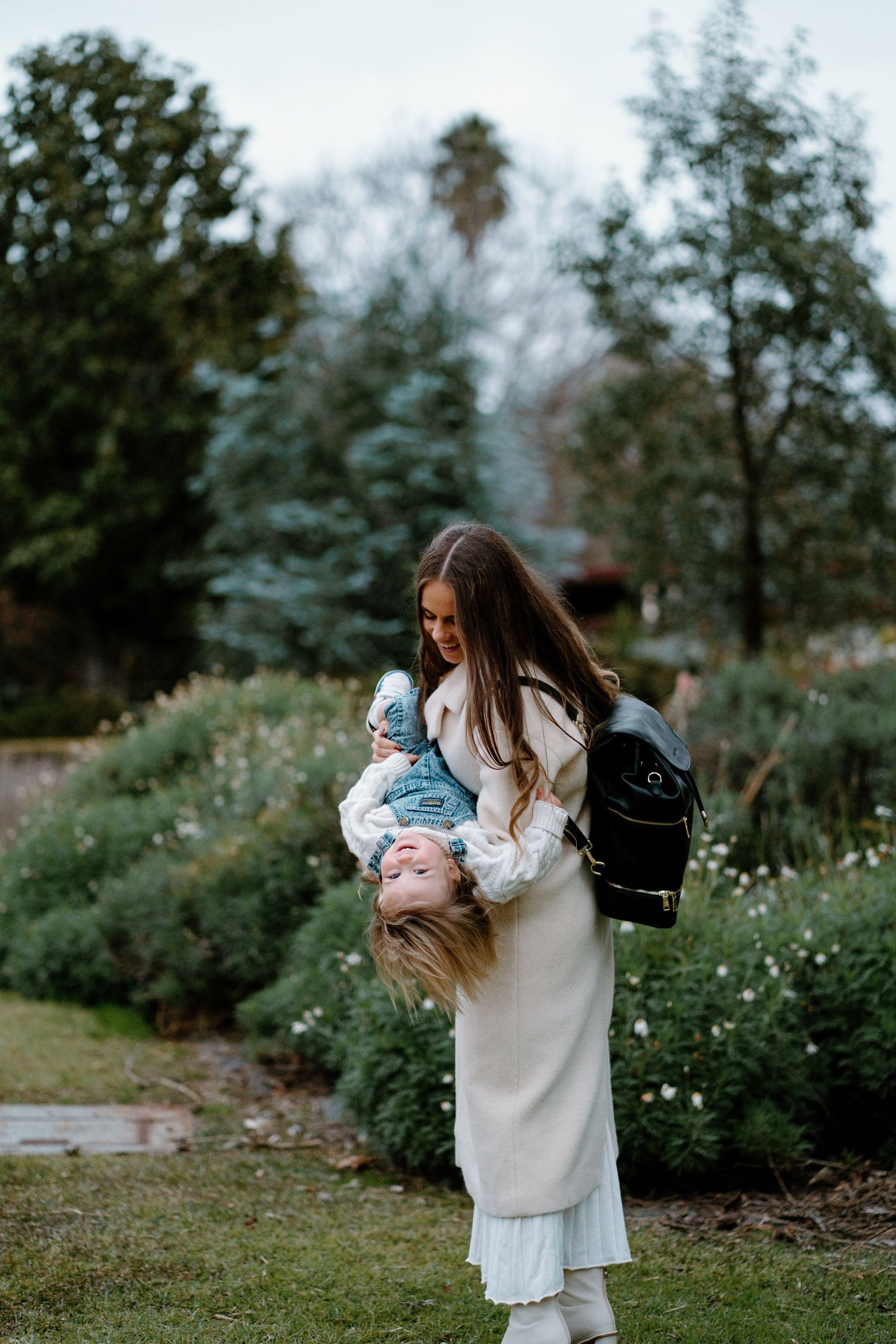 Modern parent with Siena Black Nappy Bag during outing with baby