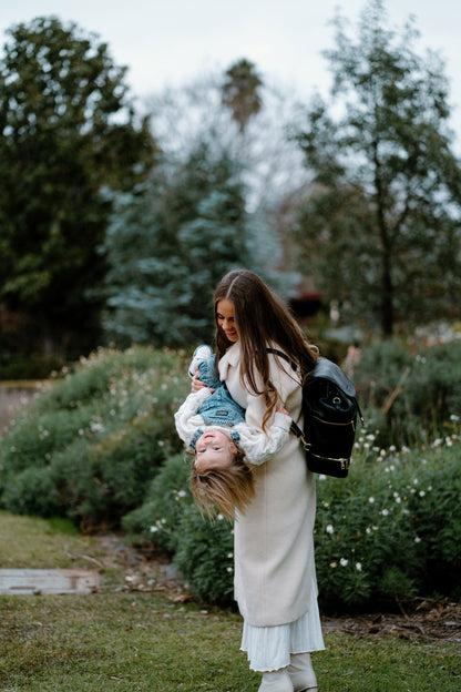 Modern parent with Siena Black Nappy Bag during outing with baby