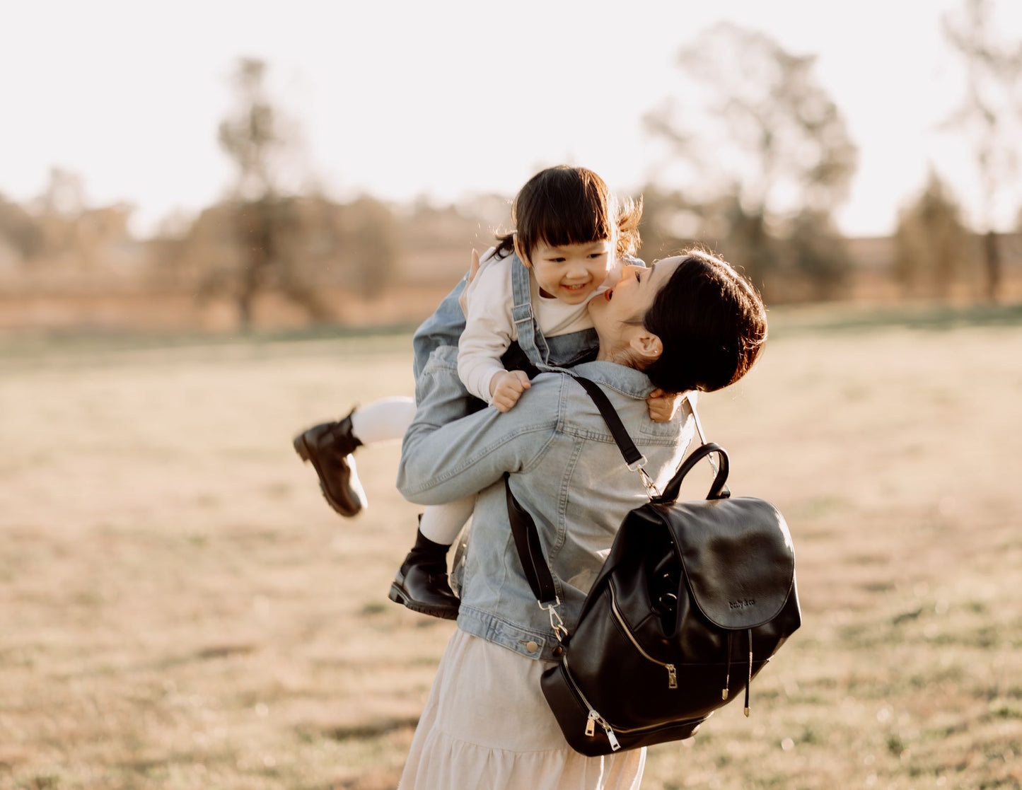 Modern parent with Siena Black Nappy Bag during outing with baby