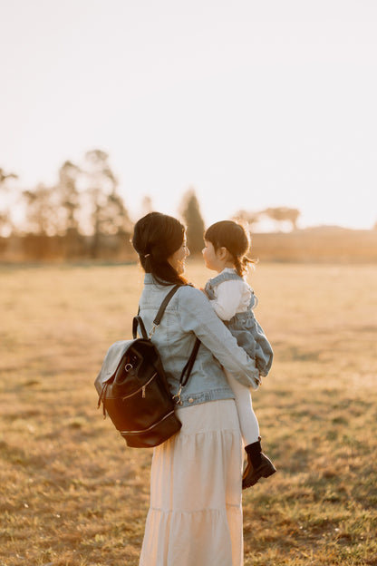 Modern parent with Siena Black Diaper Bag during outing with baby